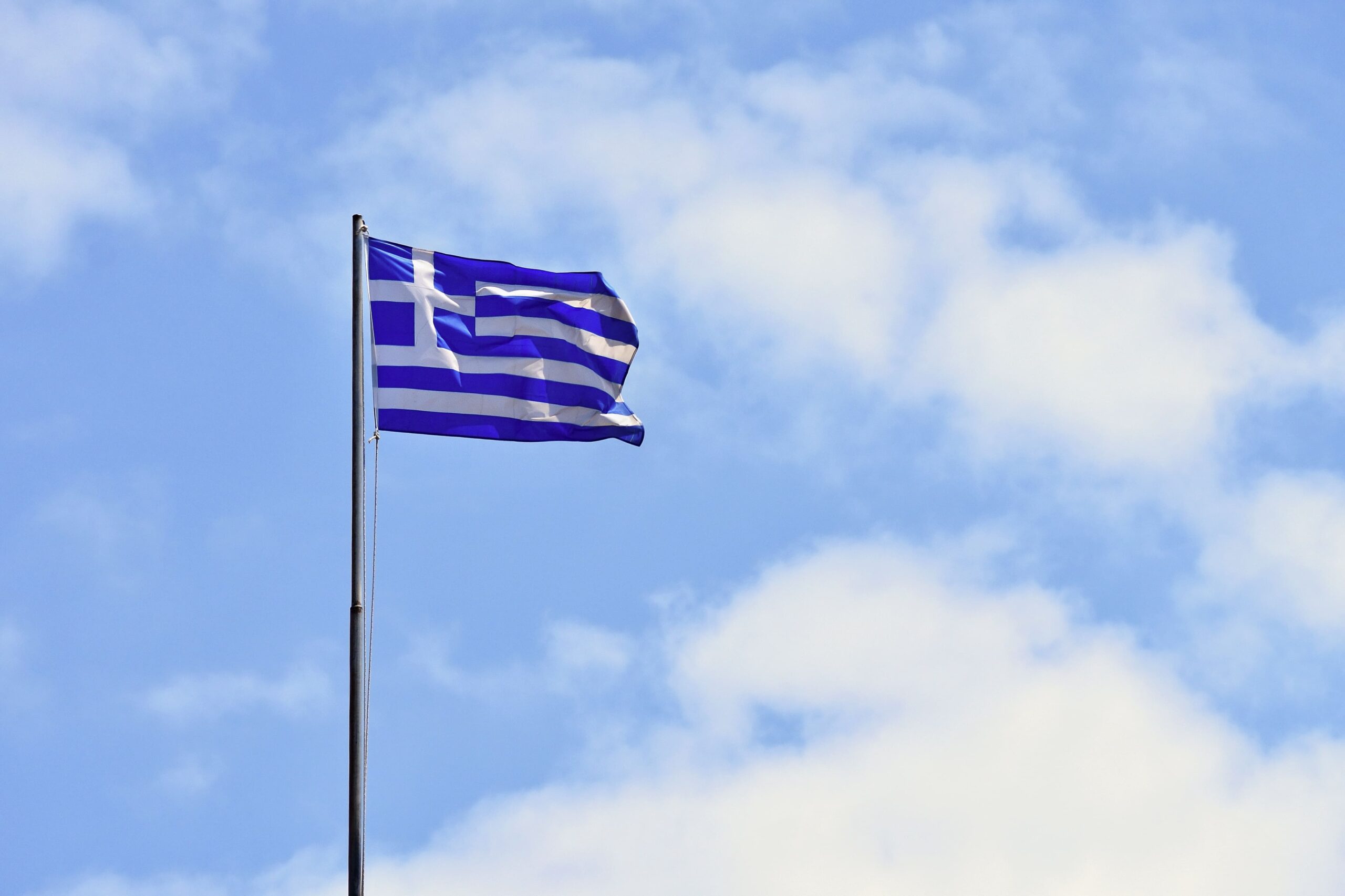 flag-greece-flying-wind-blue-sky-summer-background-travel-holidays-greece-crete